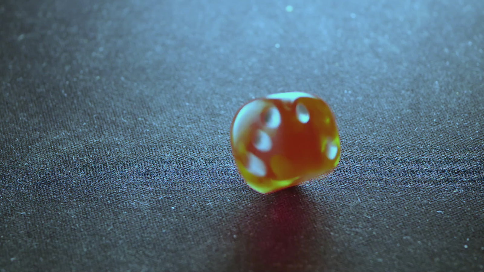 A die rolling across a tabletop